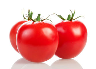 Three ripe tomatoes closeup isolated on white.