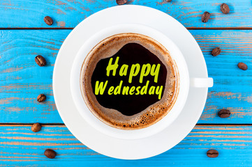 Happy Wednesday on top view coffee cup at blue wooden background with beans