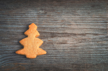 gingerbread in form of fir on the old wooden background, christm
