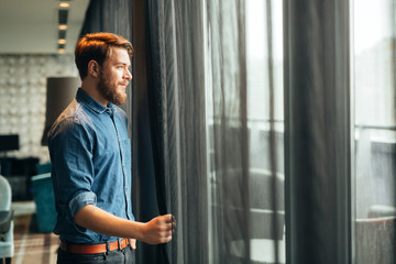 Man enjoying view from luxurious hotel room