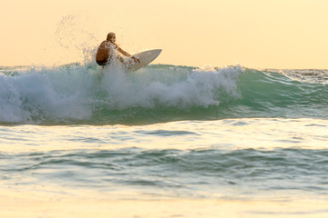 Surfer on the beach at Kata beach, Phuket, Thailand.