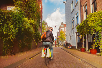 Naklejka premium Man on bike in Amsterdam