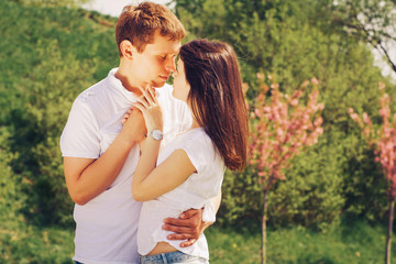 Loving young beautiful couple on a date in park. summer warm weather