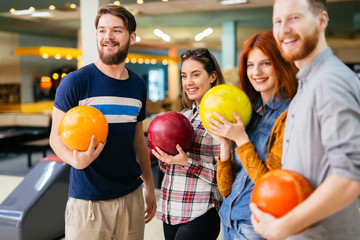 Fototapeta premium Friends enjoying bowling at club