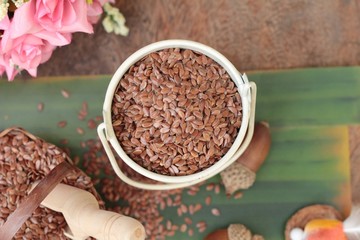 flax seeds for health on wood background.