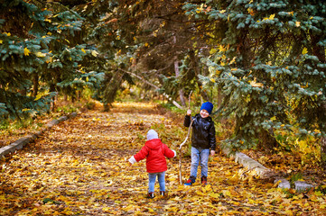 Brother and sister playing in autumn Park