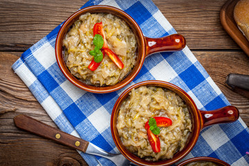 Fried cabbage greens and onion in wooden table.
