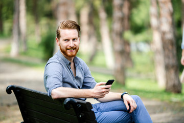 Fototapeta premium Handsome businessman using phone