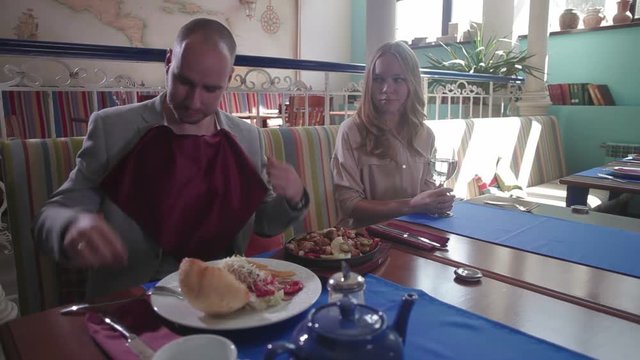 Yound woman on a diet in a restaurant with a glass of water