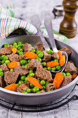 Meat stew with peas and carrots