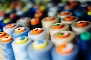 Colorful thread spools used in fabric industry © NDABCREATIVITY