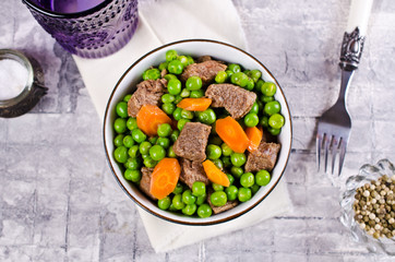 Meat stew with peas and carrots