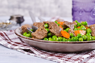 Meat stew with peas and carrots