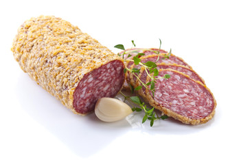 sliced salami with garlic and thyme isolated on white background