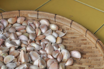 Garlic dried on wood basket background, selective focus