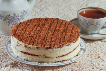 delicious cake on a plate and tea