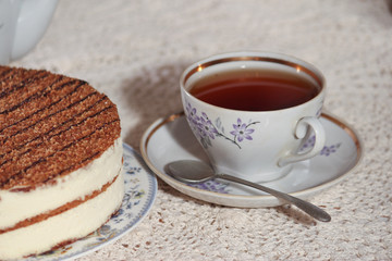 delicious cake on a plate and tea
