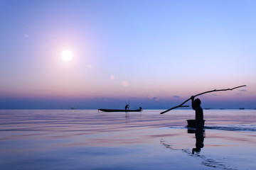 silhouette of fishermen