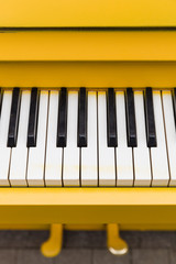 Top view on yellow piano. Closeup of piano keys. Music concept
