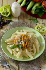 Pasta with minced meat in a frying pan on a table in a rustic st