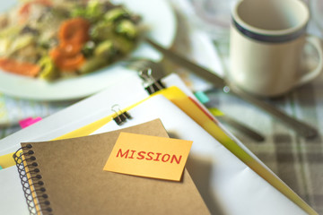 Mission; Stack of Documents. Working or Studying while Eating.