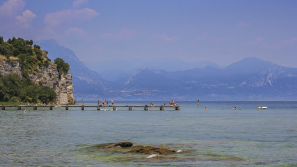 Sunbathing near a lake in Italy
