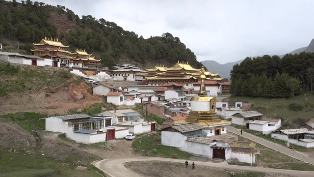 Buddhist monastery with golden rooftops in the Tibetan town of Langmusi, religion in China
