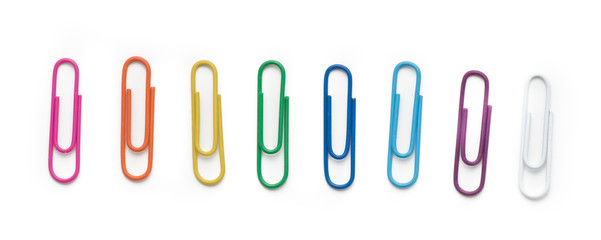 Colored paper clips on a white background. Top view.
