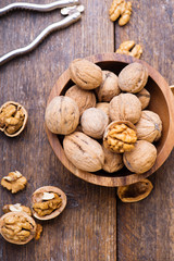 Walnuts in wooden bowl on table with Nutcracker.