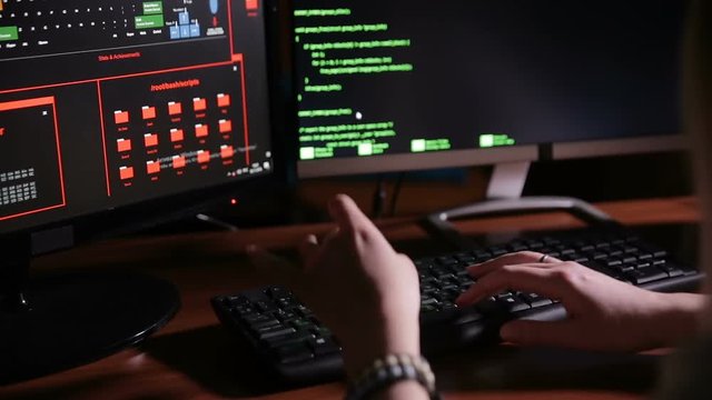 Female hands typing computer code, hacking computer at a dark room. Hacker, programmer at work. HD.