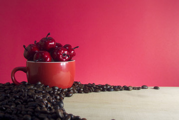 Fototapeta na wymiar coffee beans and cherry in the cup