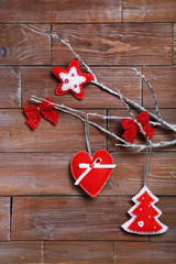 Christmas decorations hanging on rope on wooden background
