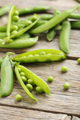 Green peas on a grey wooden table