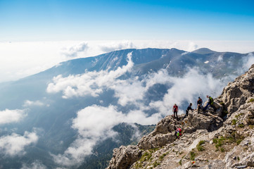 OLYMPUS NATIONAL PARK, GREECE - JULY 11, 2015: Tourists climbing the Olympus mountain in Greece.