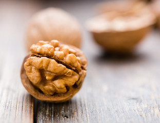 Walnuts on wooden table. Macro. Front view