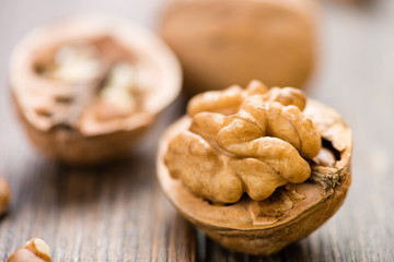 Walnuts on wooden table. Macro. Front view