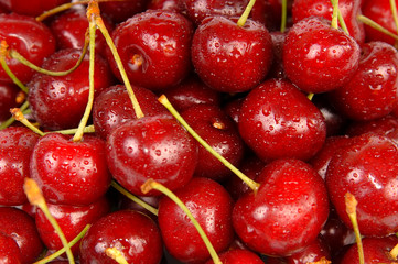 Background of ripe sweet cherry with drops and splashes water