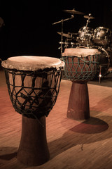 Fototapeta na wymiar Traditional wooden african djembe drumon stage