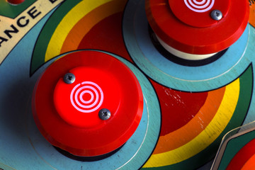 Red bumpers on a retro pinball machine