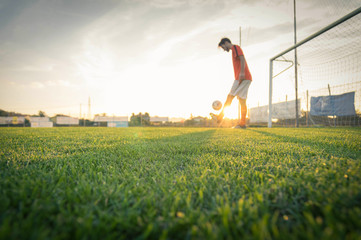 Obraz na płótnie Canvas Soccer player dribbling with the ball at the stadium.