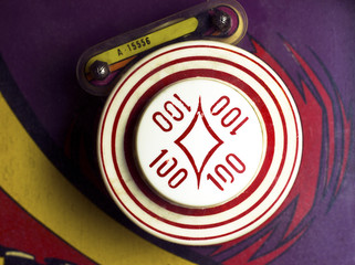 Overhead of 100-point bumper on retro pinball machine