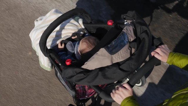 A high shot mother pushing baby in stroller