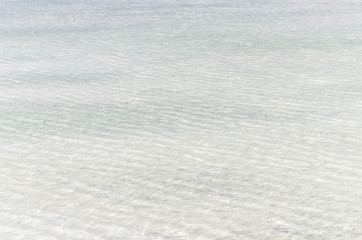 White salt surface under clear water of Baskunchak lake, Russia