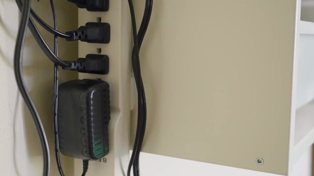 Lots of plugs and cables in surge protector