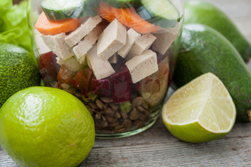 healthy salad with beets, tofu, cucumber, carrots, lentils, peas, garlic and avocado in the bank. detox and green vegetables every day.
