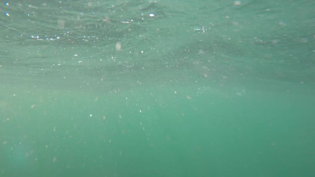 An underwater shot of rough ocean waves on the surface of the sea