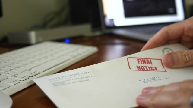 Man reads final notice foreclosure letter from bank