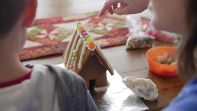 Mother and son making a gingerbread house