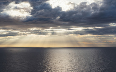 Naklejka na ściany i meble Clouds blue sky and sunlight sunset on horizon ocean . Сloudscape on background seascape dramatic atmosphere rays sunrise. Relax view waves sea with ship, mockup nature evening concept..