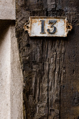 House number 13 plaque in the walled medieval town of Provins, France
